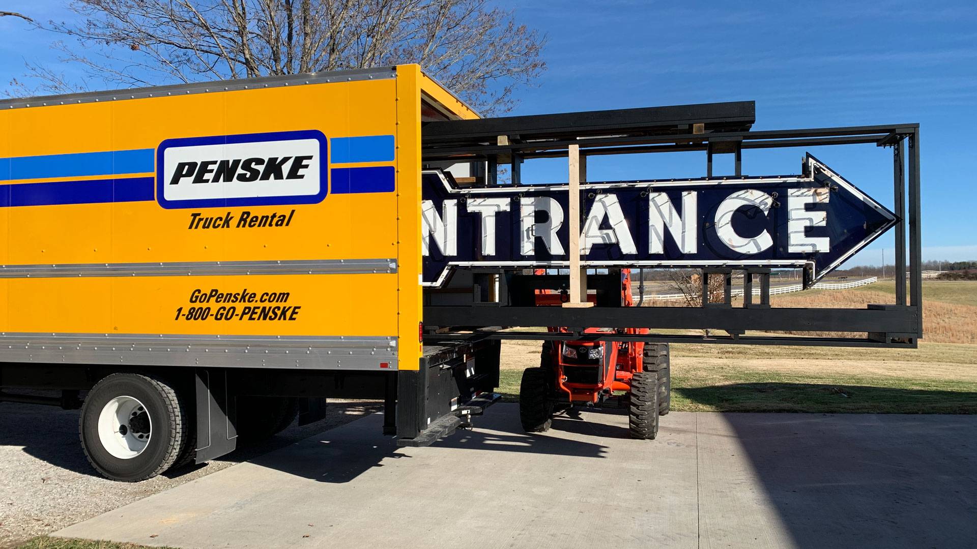 Neon road entrance arrow sign in penske truck