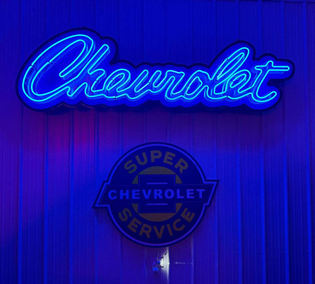 Neon road scripted chevrolet sign