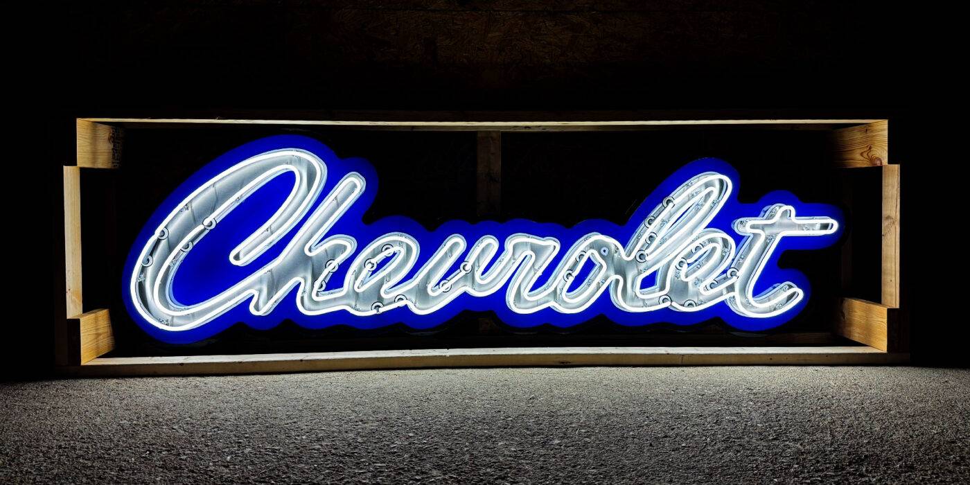 Wide shot of chevrolet script logo neon sign